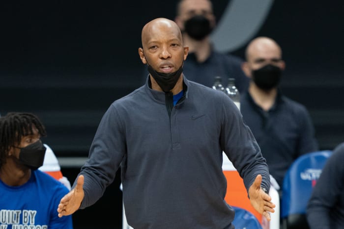 Sam Cassell stands on the sidelines.